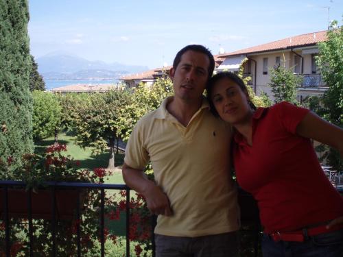 a man and a woman standing on a balcony at B&B Ore Liete in Martano