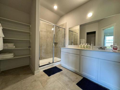 a large bathroom with a shower and a sink at Quite big home near Tesla & COTA in Del Valle