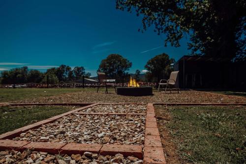 a fire pit in the middle of a yard at Lusso - Boutique Accommodation in Whitfield