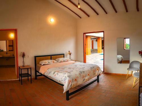a bedroom with a large bed in a room at Casa Peak Barichara in Barichara