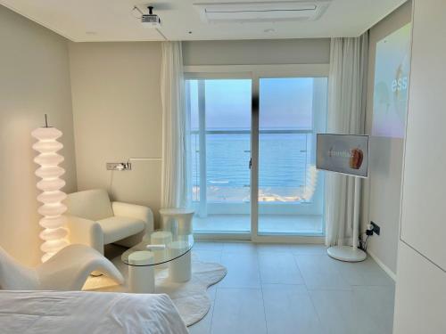 a bedroom with a bed and a view of the ocean at Le Bleu Naksan by Orot in Yangyang