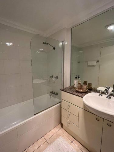 a bathroom with a tub and a sink and a shower at Nature at your Doorstep in Katoomba