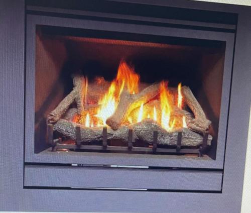 a fire in an oven with some food in it at Nature at your Doorstep in Katoomba
