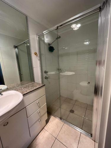 a bathroom with a glass shower and a sink at Nature at your Doorstep in Katoomba