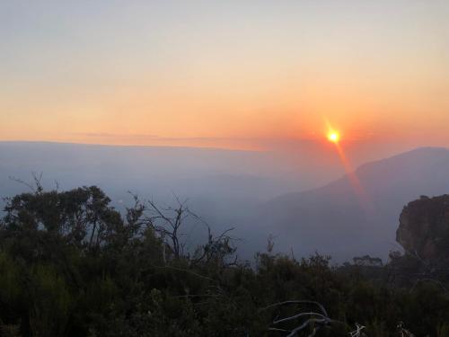 a view of the sun setting over the mountains at Nature at your Doorstep in Katoomba