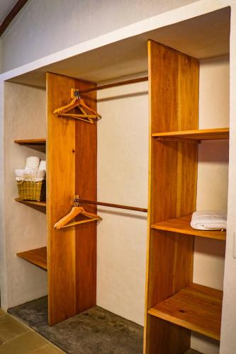 a closet with wooden shelves and a refrigerator at Casa Peak Barichara in Barichara