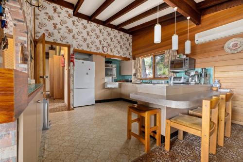 a kitchen with a table and chairs in a room at Elvira Ski Lodge in Jindabyne