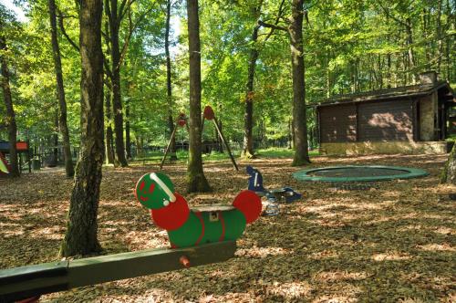 a playground with a teddy bear on a bench in a park at Village de Vacances d'Oignies in Oignies-en-Thierache