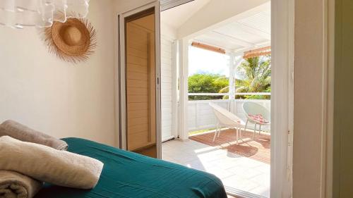 a room with a sliding glass door leading to a patio at Kaz 4 plages - Accès plages & Vue Mer in Deshaies