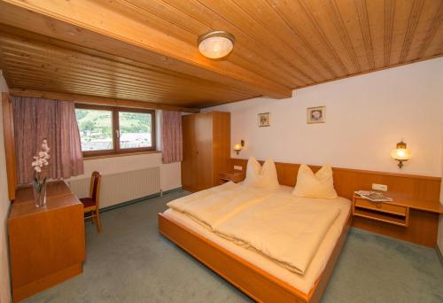 a bedroom with a large bed with a wooden ceiling at Appartement Kristall in Zell am See