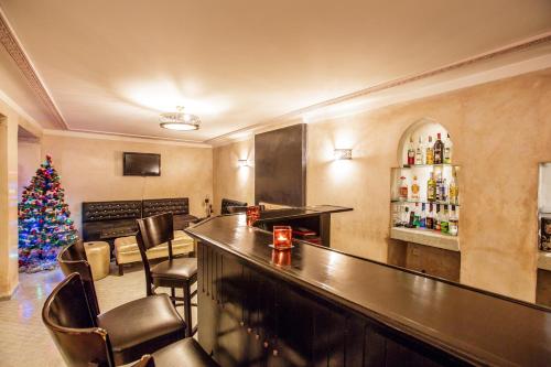 a bar with a christmas tree in a room at Riad Andalib in Fès