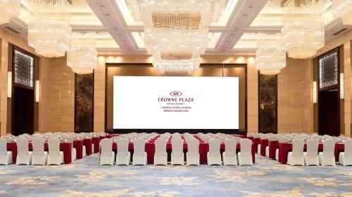 a conference room with chairs and a projector screen at Crowne Plaza Chengdu Panda Garden by IHG-Near Panda Base in Chengdu
