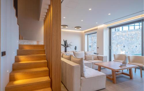 a living room with a staircase and a table at Beautiful Home In Heraklio Crete in Lygaria