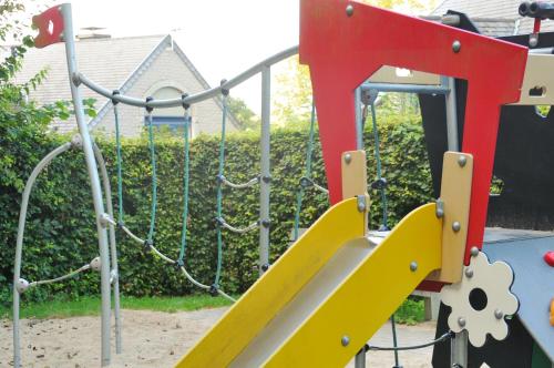 a playground with a yellow and red slide at Résidence Durbuy in Durbuy