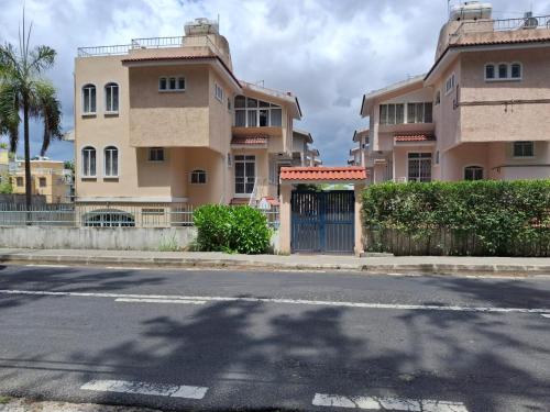 an empty street in front of a building at Beachfront 4-Bedroom Villa with Rooftop Sunset Terrace in Flic-en-Flac