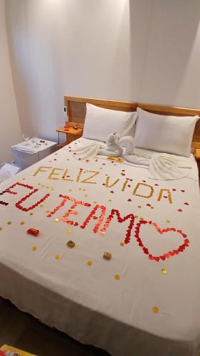 a bed with a happy new year written on it at Pousada Solarium in Canoa Quebrada