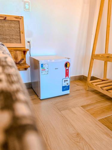 a small refrigerator sitting on the floor in a room at Pousada Solarium in Canoa Quebrada