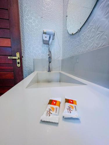 two towels sitting on a counter next to a sink at Pousada Solarium in Canoa Quebrada