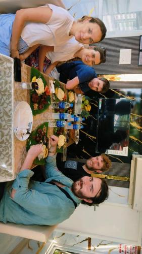 a group of people standing around a table with food at Beach Paradise Day Cruise Houseboat in Alleppey