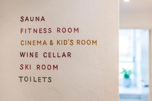 a sign on a wall with different words on it at Boutique Hotel Am Park in Valdaora