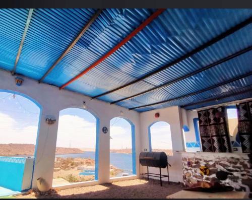 a room with a blue ceiling with a view of the ocean at Asilah kato nubian guest house in Aswan