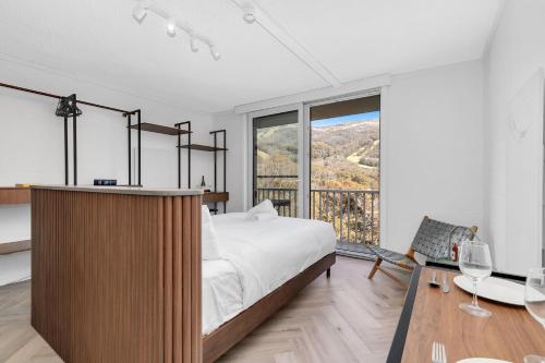 a bedroom with a bed and a large window at Byadbo 5 in Thredbo
