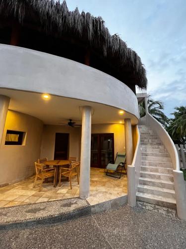 a house with a staircase leading up to a patio at Villas Cononda in La Majahua