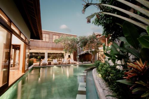 a swimming pool in the middle of a building at Seminyak Villa Paya paya Luxury near beach-Potato Head in Seminyak