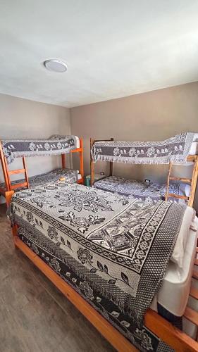 two bunk beds sitting in a room with at Lodelore in Merlo