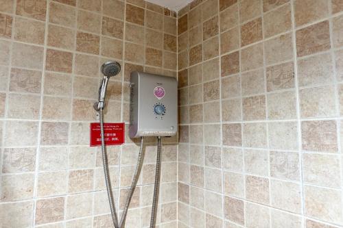 a shower in a corner of a tiled wall at SK House 2 in Chiang Mai