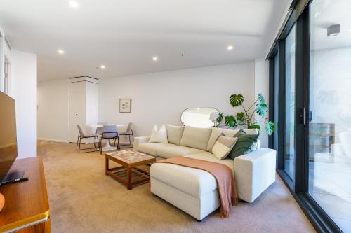 a living room with a couch and a table at Serene 2BR Apt in the Radiant City of Civic - Hosted by Canstay in Canberra