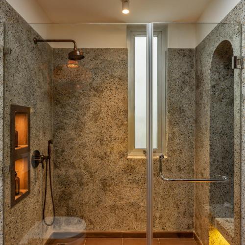 a shower with a glass door in a bathroom at La Verona - 2,3,4 BHK Villas in Assagao with Private Pool, Garden, Caretaker, Kitchen & Security in Assagao