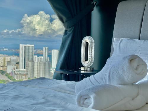 a room with a bed with a number zero at Cozy Urban Suites Georgetown View in Jelutong