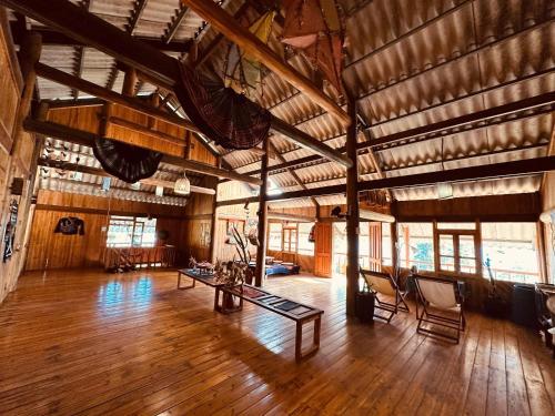 a large room with wooden floors and wooden ceilings at La Beauté Sa Pa in Sa Pa