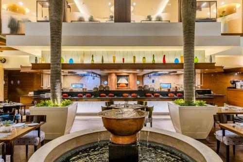 a restaurant with a fountain in the middle at Vivanta Goa, Panaji in Panaji