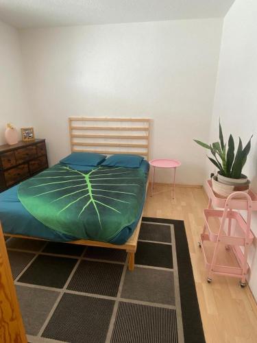 a bedroom with a bed and a chair and a plant at Habitación Privada en La Colonia Roma in Mexico City
