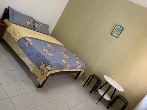 a bedroom with a bed with a blanket with butterflies on it at Nadi Airport rooms in Nadi