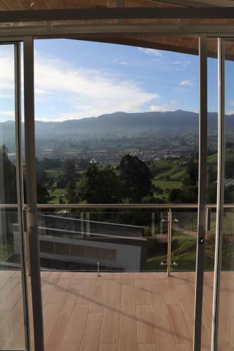 a view from the balcony of a house at Glamping en Hermosa Granja in Cogua