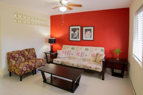 a living room with a couch and a chair at Ocean Villa Guam in Tamuning