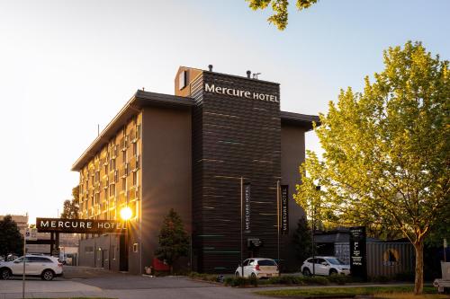 a hotel building with cars parked in front of it at Mercure Albury in Albury