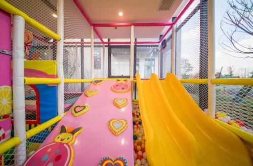 a playground with a slide in a building at Best Boutique Hotel in Nanhui