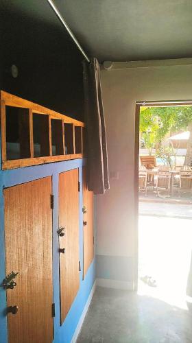 an empty room with a door and a window at Jati Village, Party Hostel and Bungalows in Gili Trawangan