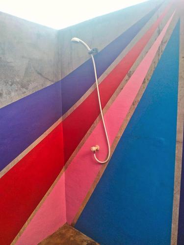 a room with a pole sticking out of a wall at Jati Village, Party Hostel and Bungalows in Gili Trawangan