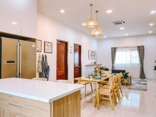 a kitchen and dining room with a table and chairs at Click Residence, Si Muang in Vientiane