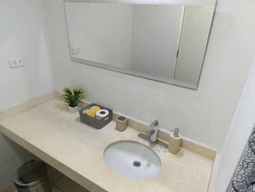 a bathroom counter with a sink and a mirror at MIRAFLORES APART-10Beds-11Persons-Pool-Grill-Garage-Near Kennedy Park in Lima