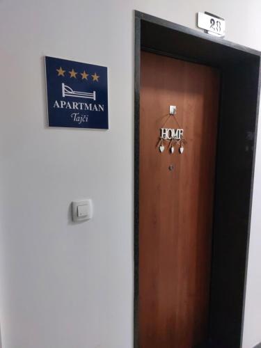 a door in a room with a sign on it at Apartman Tajči in Koprivnica