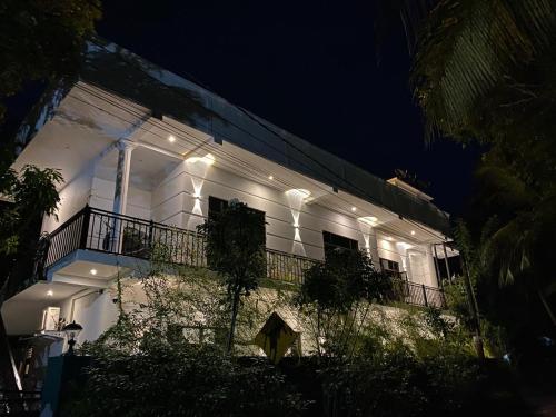 a white building with lights on it at night at Ceylon Avenue in Habaraduwa
