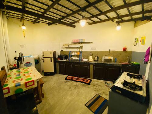 a kitchen with a counter and a refrigerator at Ceylon Avenue in Habaraduwa