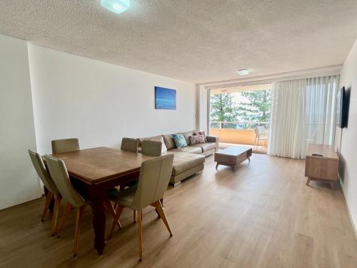 a living room with a table and a couch at Park Towers-Goodwin Towers Holiday Units in Gold Coast