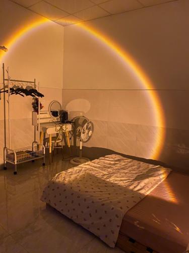 a room with a bed with a rainbow on the wall at Homestay Tuyết Trinh in Nha Trang